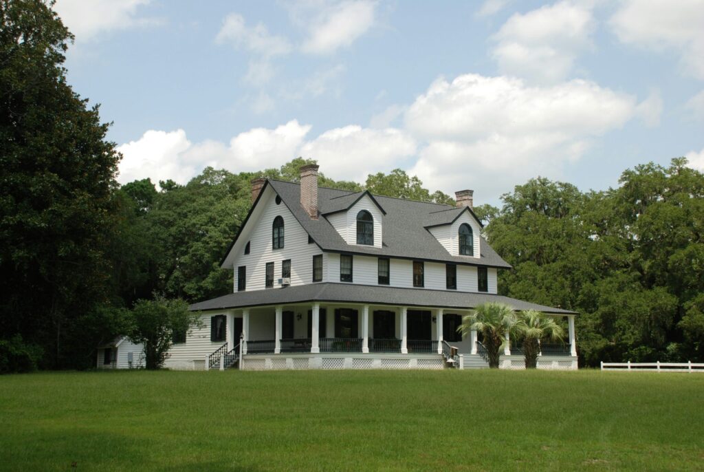 white and black house near green grass field