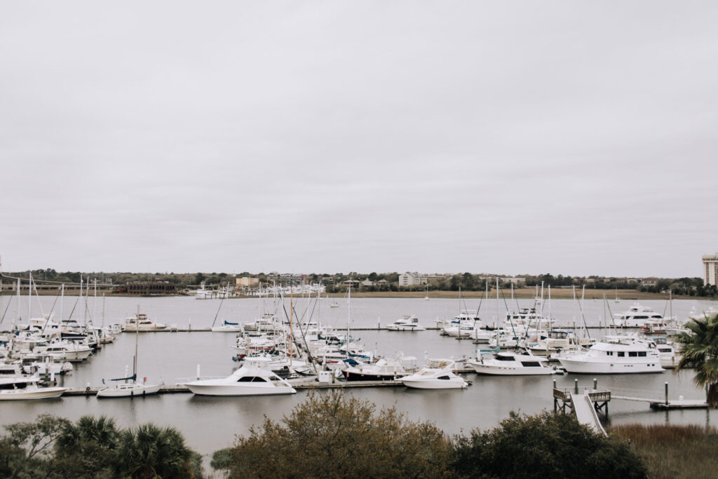 a view of boats near a dock on a cloudy weather